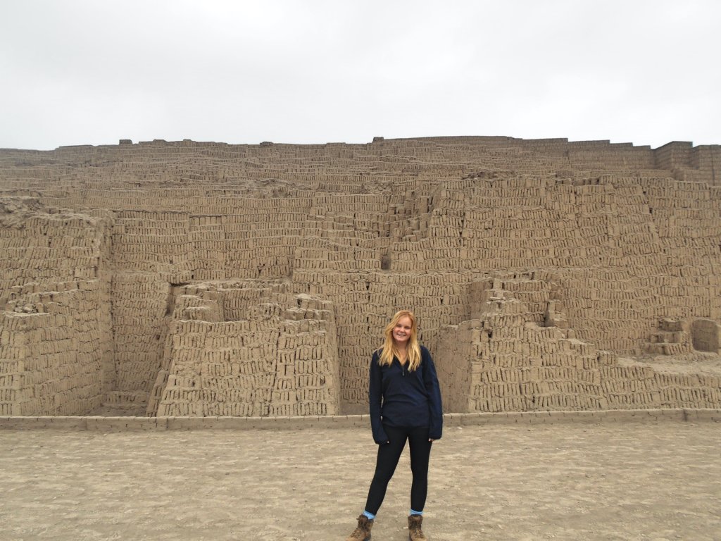 woman in front of inca ruins a unique place to visit in peru
